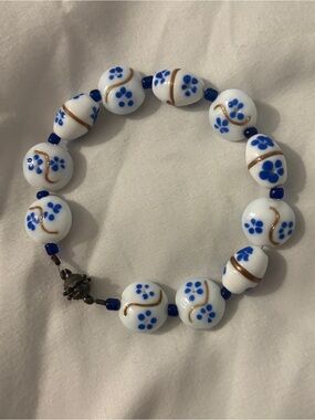 White Glass Beaded Bracelet with Blue Floral Accents and Magnetic Closure